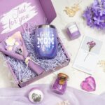 A purple gift box with a 12 oz. "Best Mom Ever" tumbler, knitted flower, heart soap, bath bomb, bath salt, and candle.