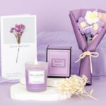 A purple gift box with a 12 oz. "Best Mom Ever" tumbler, knitted flower, heart soap, bath bomb, bath salt, and candle.