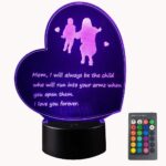 Heart-shaped 3D lamp with a child running to a mother, glowing with multicolor LED light on a dark background.