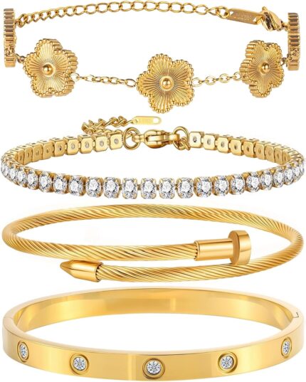 Close-up of four GIVCHO 18K gold plated stainless steel bangle bracelets with clear cubic zirconia stones.