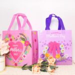 A set of 16 rose-colored HADDIY Mother's Day gift tote bags with floral patterns and handles, displayed together.