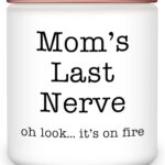 A pink and white round Homsolver 'Mom's Last Nerve' lavender-scented soy candle in a jar, with a lit wick.