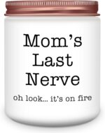 A pink and white round Homsolver 'Mom's Last Nerve' lavender-scented soy candle in a jar, with a lit wick.