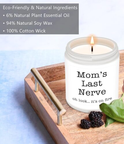 A pink and white round Homsolver 'Mom's Last Nerve' lavender-scented soy candle in a jar, with a lit wick.