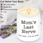 A pink and white round Homsolver 'Mom's Last Nerve' lavender-scented soy candle in a jar, with a lit wick.