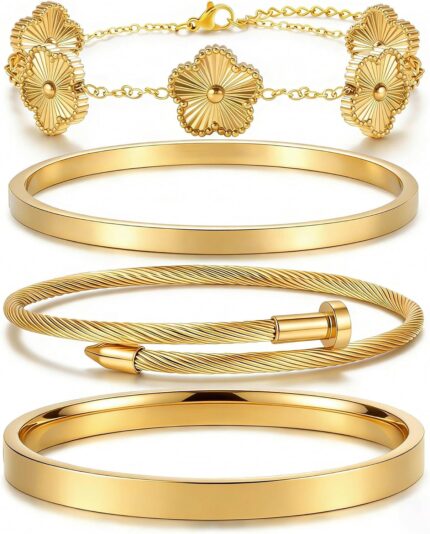 Two ISELBDR 18K gold plated stainless steel bangles, one with a clover design and one with a nail design, stacked together.