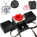 A red preserved rose in a gift box with a heart-shaped pendant necklace, illuminated by warm lights.