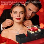 A red preserved rose in a gift box with a heart-shaped pendant necklace, illuminated by warm lights.