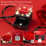 A red preserved rose in a gift box with a heart-shaped pendant necklace, illuminated by warm lights.