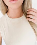 Close-up of a 14K gold plated 'Mama' pendant necklace on a delicate cable chain, with a glossy finish.
