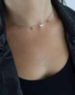 Close-up of a 14K gold plated 'Mama' pendant necklace on a delicate cable chain, with a glossy finish.
