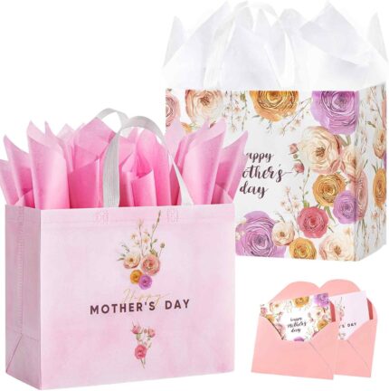 Two large pink floral gift bags with handles, tissue paper, greeting cards, and stickers for Mother's Day gifts.