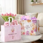Two large pink floral gift bags with handles, tissue paper, greeting cards, and stickers for Mother's Day gifts.