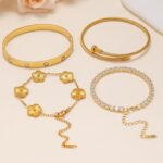 Four Zesnoy 18K gold-plated stackable clover bangle bracelets on a white background, showcasing their shine.